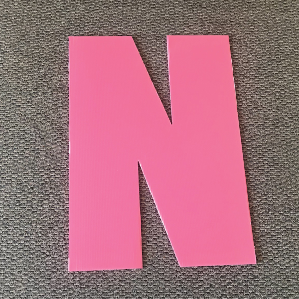 letter-n-pink-yard-greetings-cards-lawn-signs-happy-birthday-over-hill